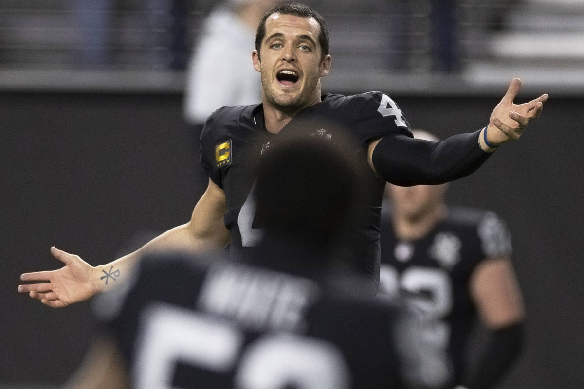 Raiders quarterback Derek Carr (4) warms up before the start of an NFL football game against th ...