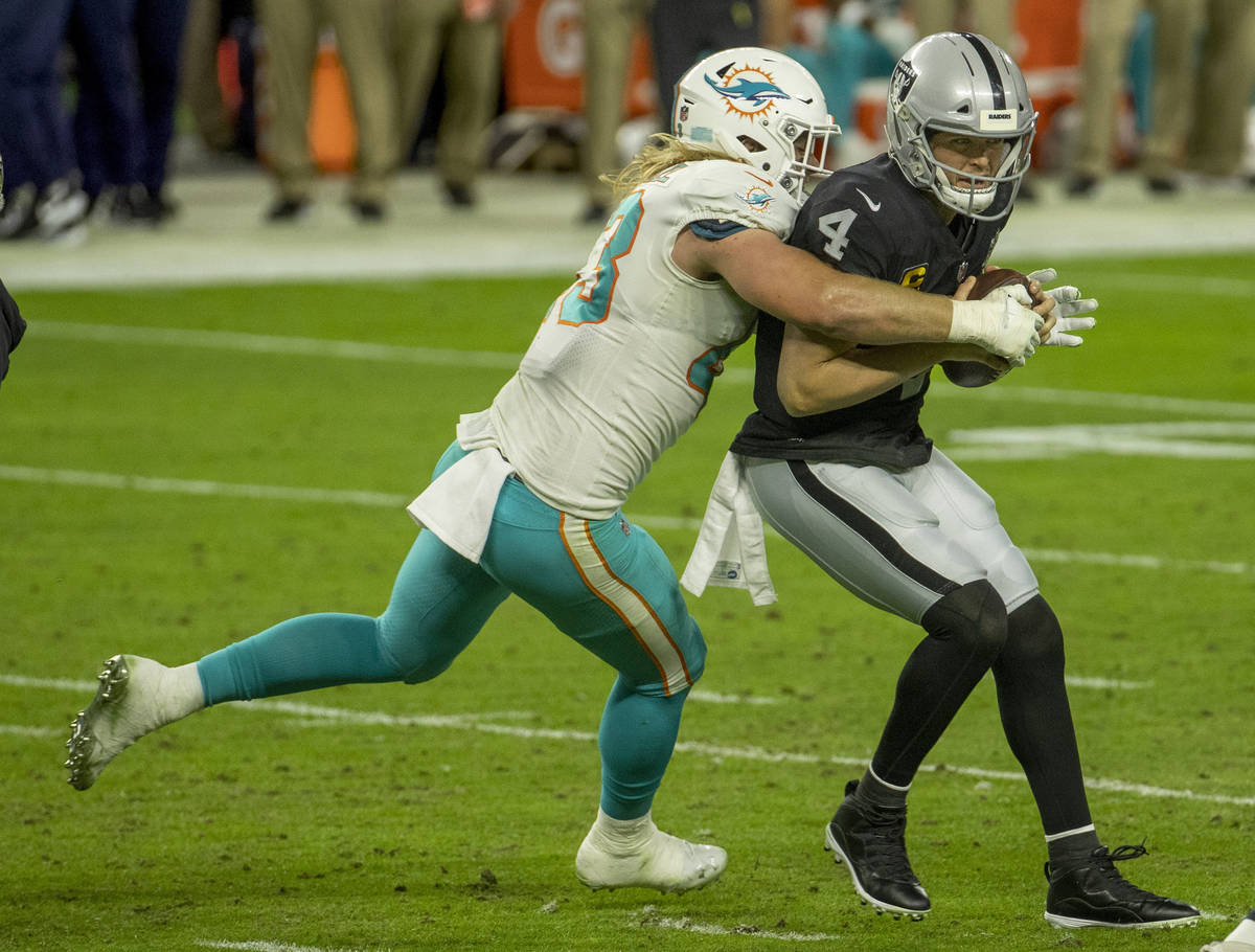 Raiders quarterback Derek Carr (4) is sacked by Miami Dolphins outside linebacker Andrew Van Gi ...