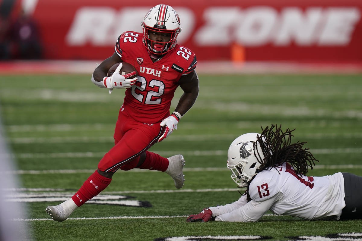 FILE - In this Dec. 19, 2020, file photo, Utah running back Ty Jordan (22) runs for a score as ...