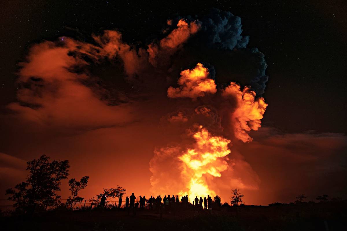 People watch an eruption from Hawaii's Kilauea volcano on the Big Island on Sunday, Dec. 20, 20 ...
