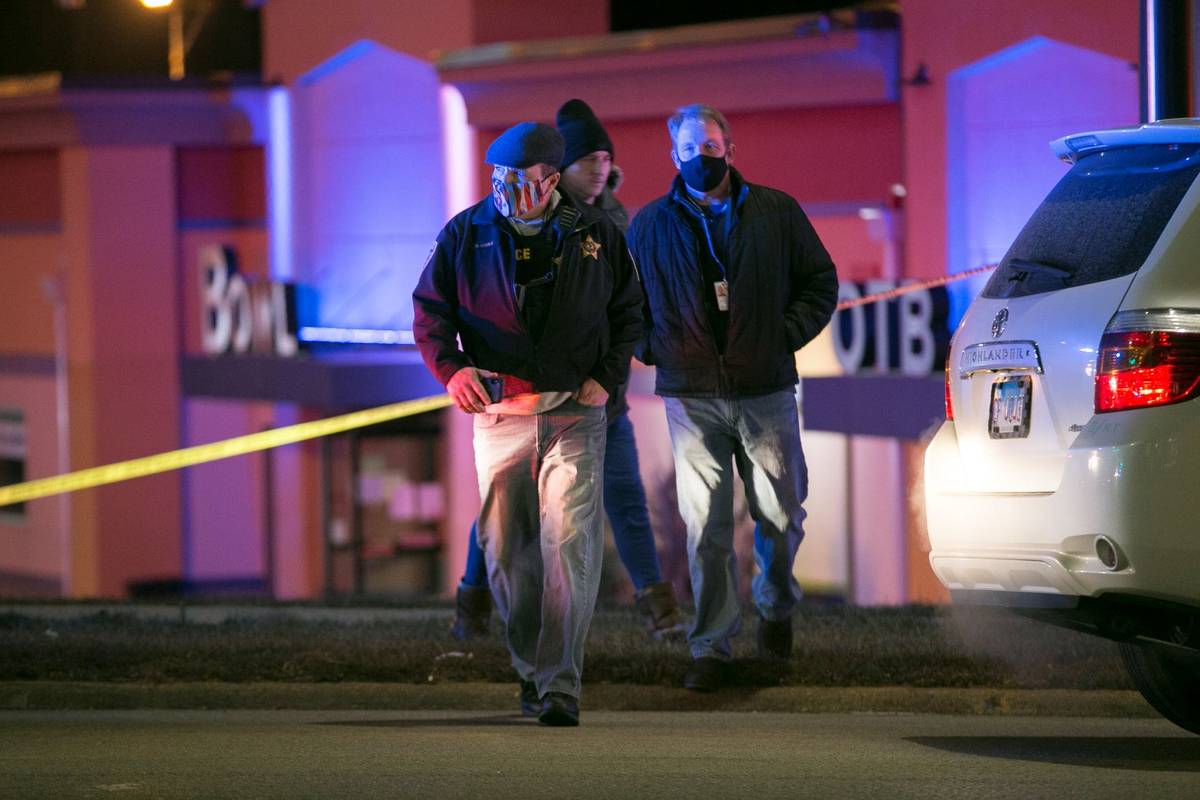 Rockford Police Chief Dan O'Shea, left, walks to a media staging area at the scene of a shootin ...