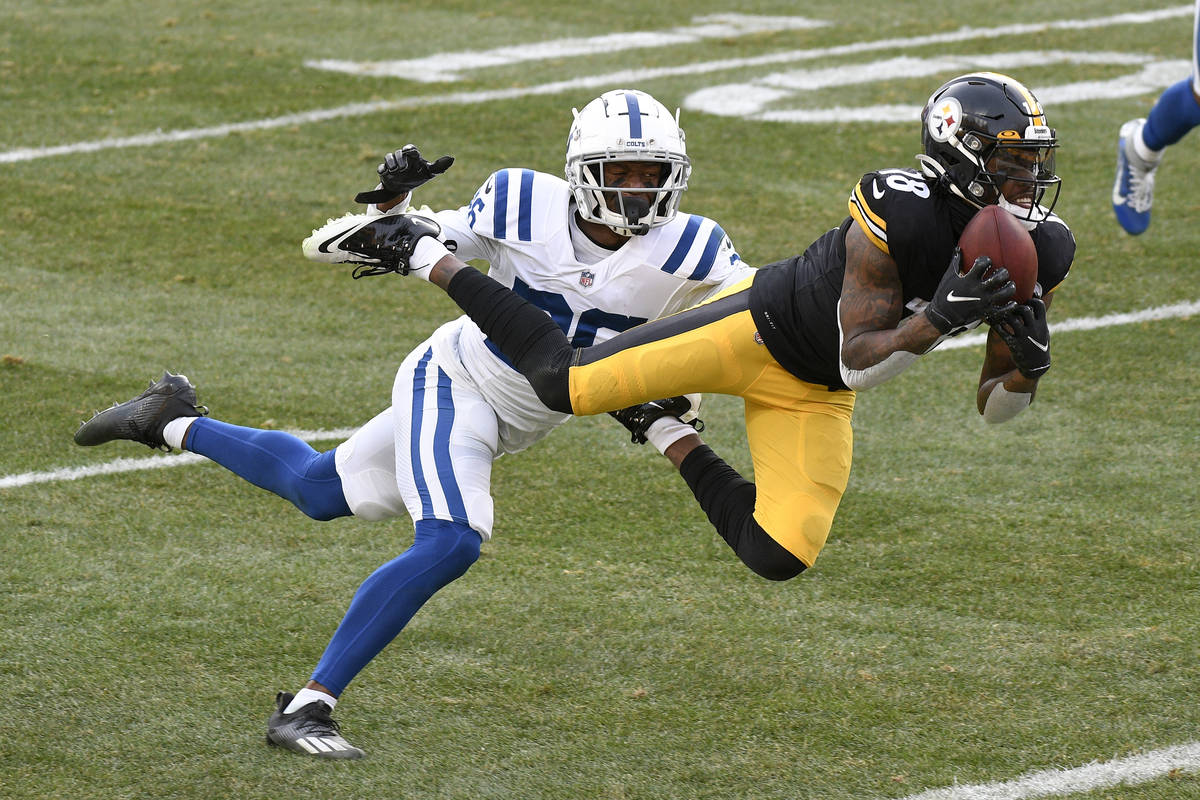 Pittsburgh Steelers wide receiver Diontae Johnson (18) makes a catch past Indianapolis Colts co ...