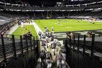 The Raiders take the field at an empty Allegiant Stadium during an NFL football game against th ...