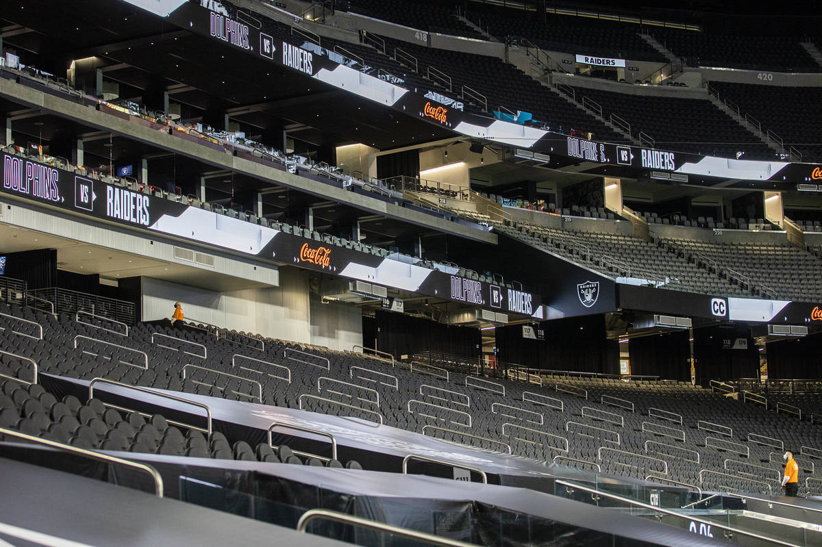 The seats at Allegiant Stadium are filled with a single usher during an NFL football game betwe ...