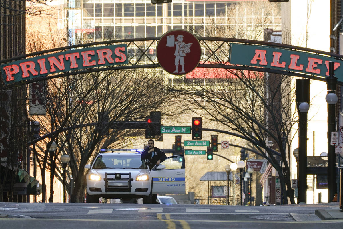 A police officer blocks a street as the investigation continues into an explosion Saturday, Dec ...