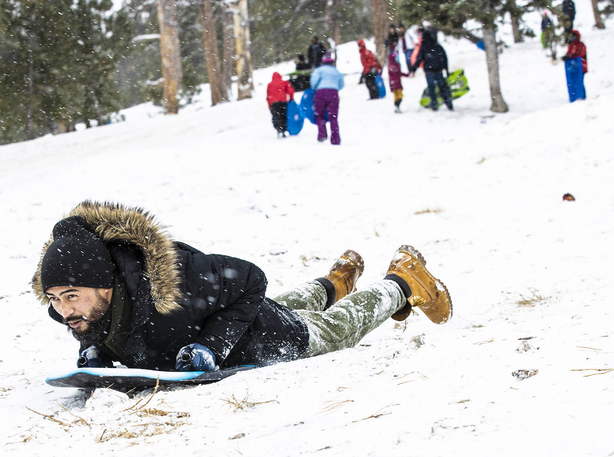 Roy Imperial sleds down a hill at Lee Canyon on Monday, Dec. 28, 2020, in Las Vegas. (Benjamin ...