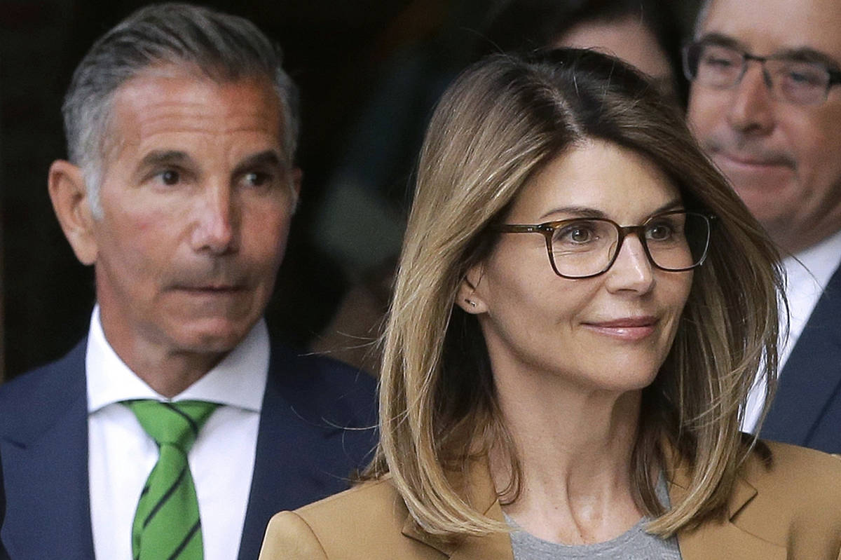 In this April 3, 2019 file photo, actor Lori Loughlin, front, and husband, clothing designer Mo ...