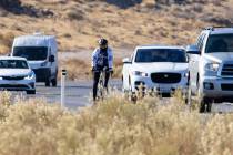 A cyclist rides his bike along the Charleston Blvd near Red Rock, on Tuesday, Dec. 29, 2020, in ...