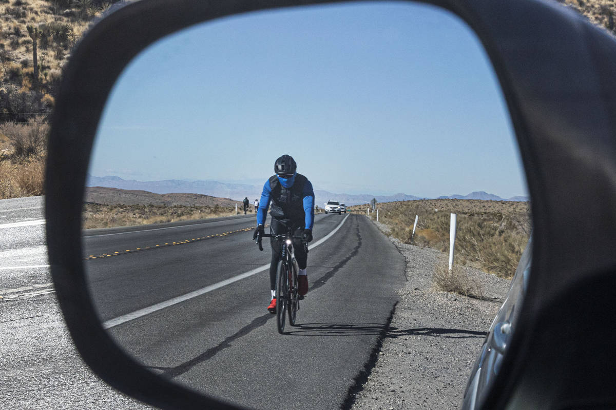 A cyclist rides his bike along the Charleston Blvd near Red Rock, on Tuesday, Dec. 29, 2020, in ...