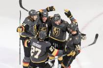 Vegas Golden Knights celebrate a goal during the third period of an NHL hockey playoff game aga ...