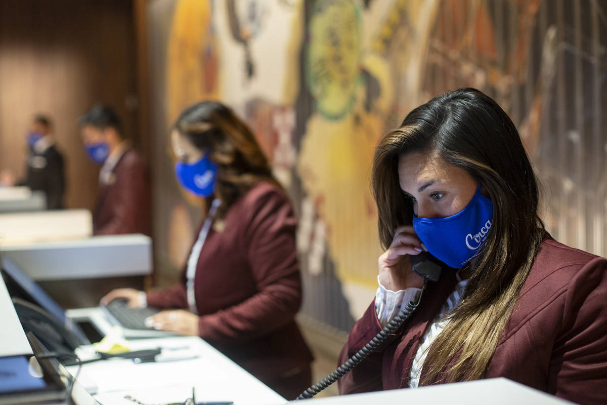 Front desk agent Ciara Murillo, right, answers phone calls on one of the first days guests stay ...