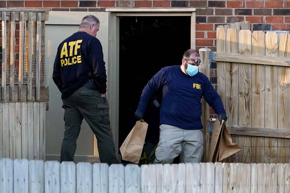 Investigators remove items from the basement of a home Saturday, Dec. 26, 2020, in Nashville, T ...