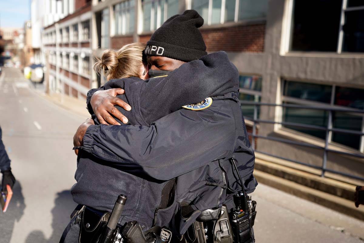 Nashville Police officers Brenna Hosey, left, and James Wells embrace after speaking at a news ...