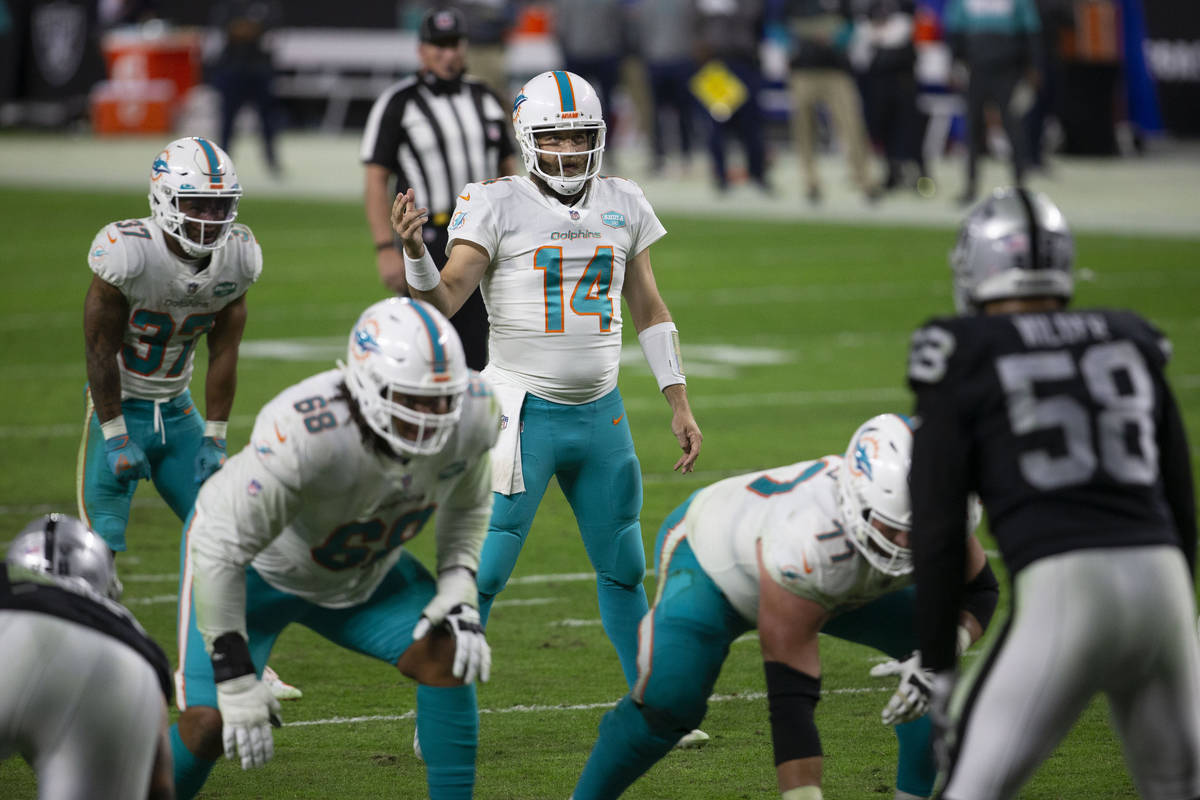 Miami Dolphins quarterback Ryan Fitzpatrick (14) calls a play at the line of scrimmage during t ...