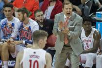 UNLV Rebels head coach T.J. Otzelberger, top/right, directs his team during their NCAA basketba ...