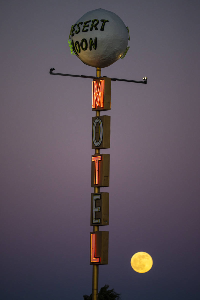 The last full moon of the year rises above the Desert Moon Motel sign on east Fremont Street in ...