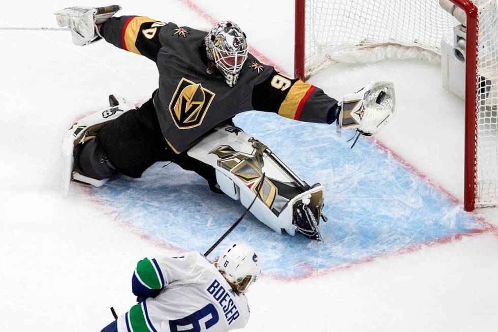 Vancouver Canucks' Brock Boeser (6) is stopped by Vegas Golden Knights goalie Robin Lehner (90) ...