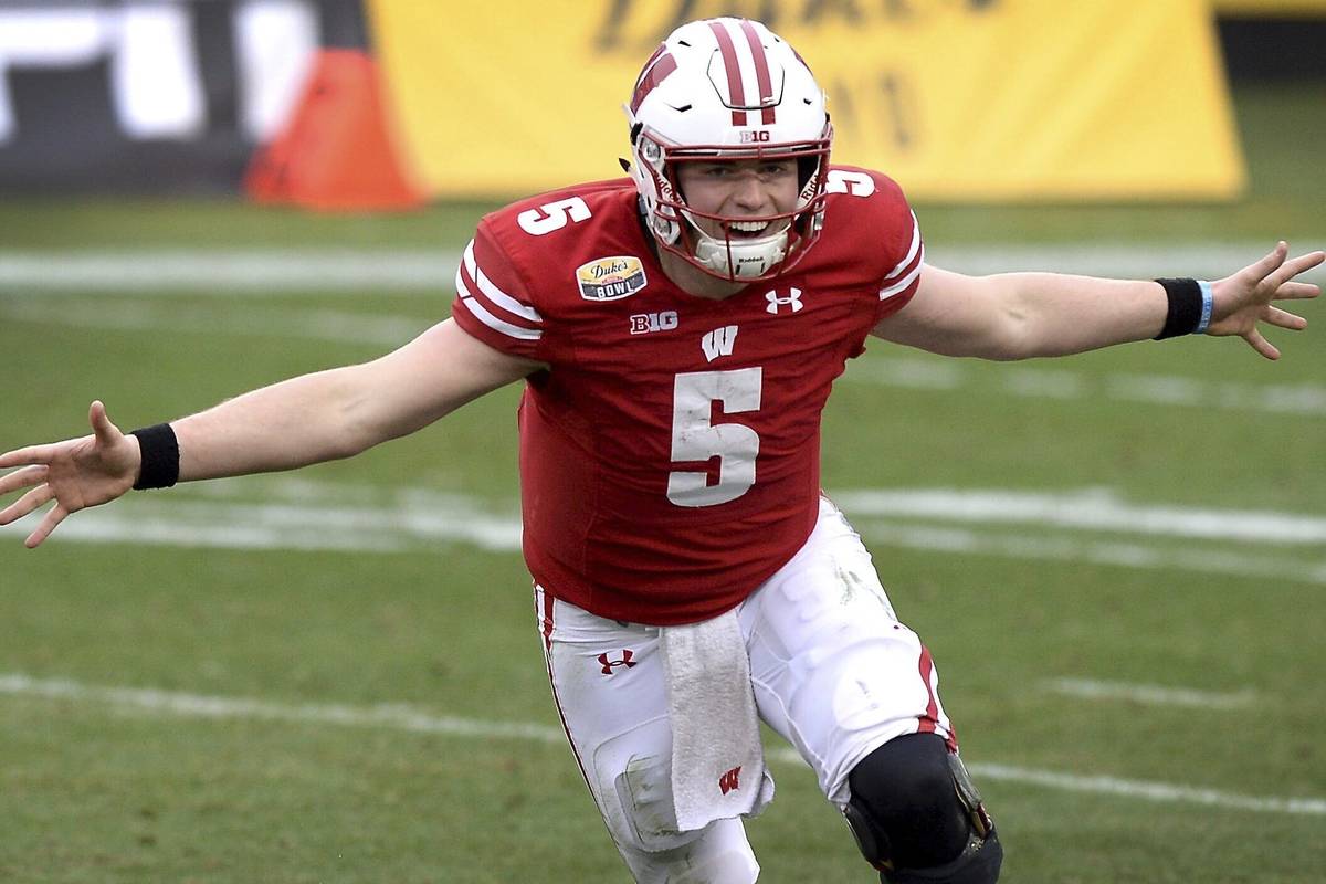 Wisconsin quarterback Graham Mertz celebrates they defeated Wake Forest in the Duke's Mayo Bowl ...