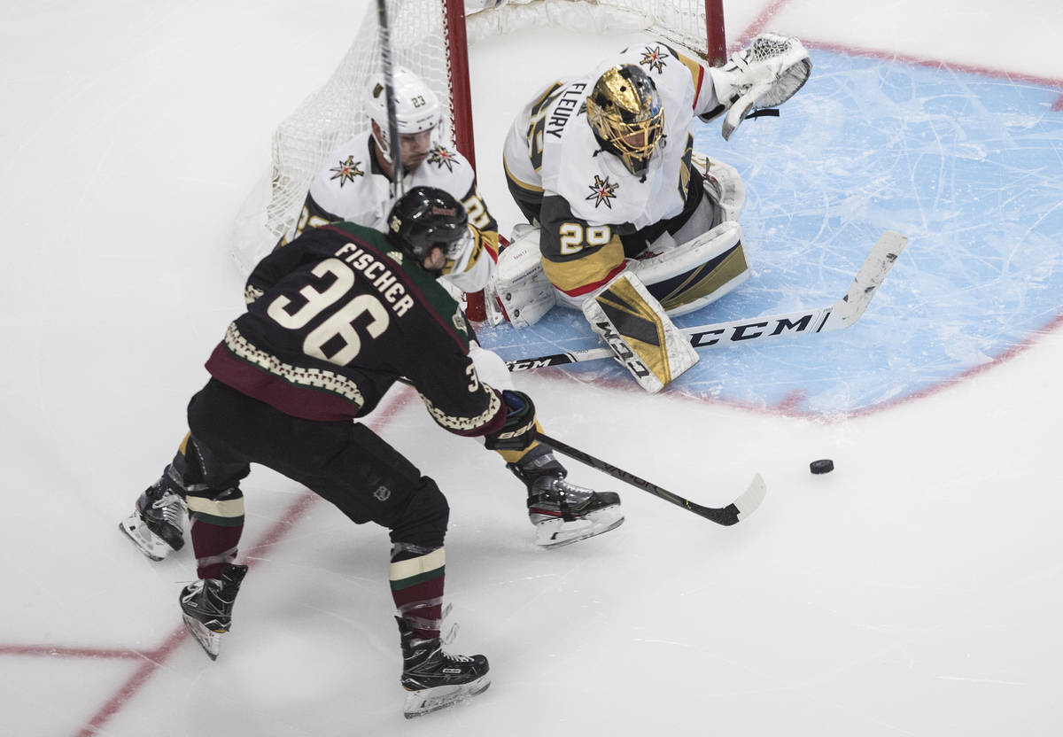 Arizona Coyotes' Christian Fischer (36) is stopped by Vegas Golden Knights goalie Marc-Andre Fl ...
