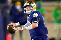 Notre Dame quarterback Ian Book looks for a receiver during the first quarter against Clemson i ...