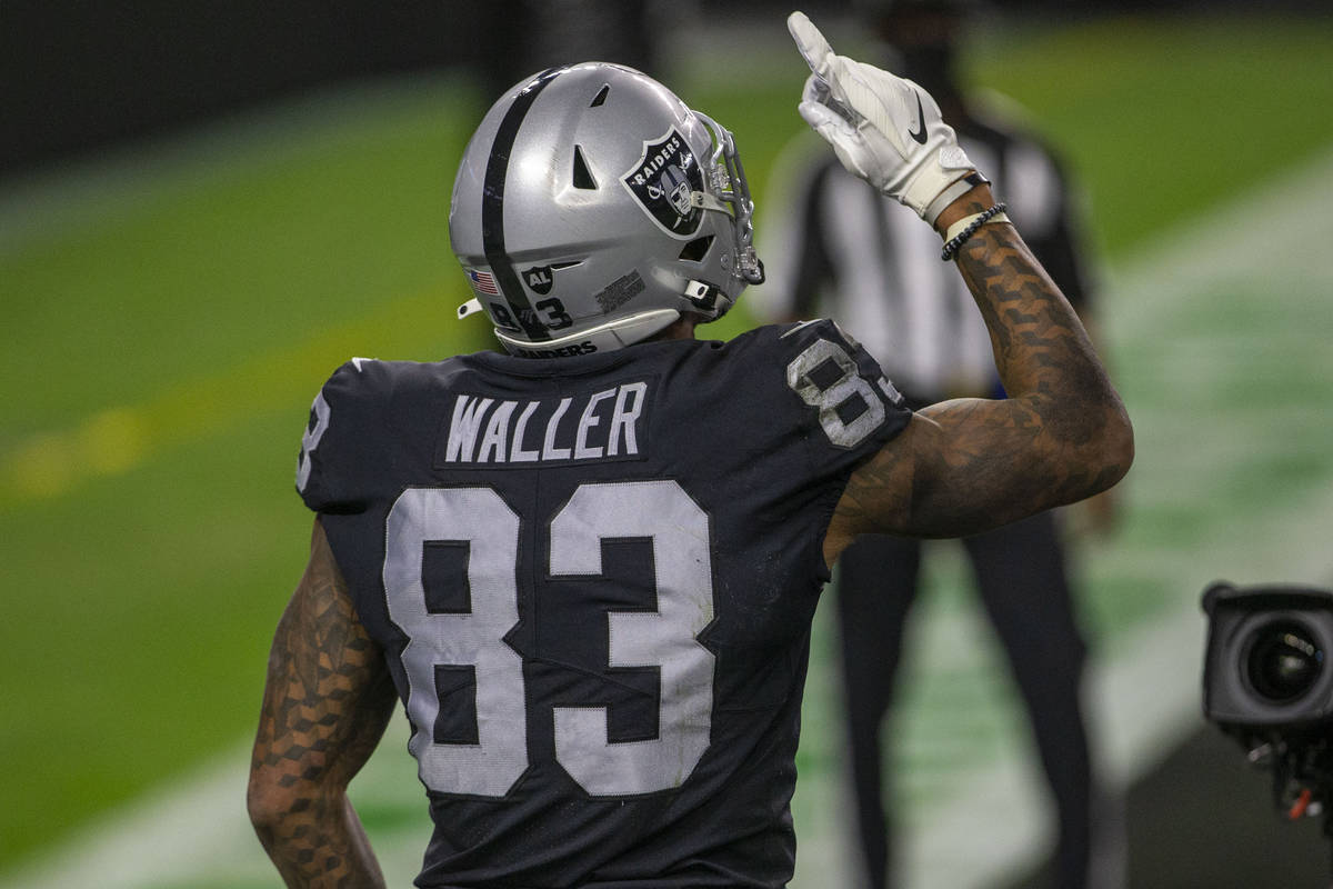 Raiders tight end Darren Waller (83), raises one finger to the sky after scoring a touchdown du ...