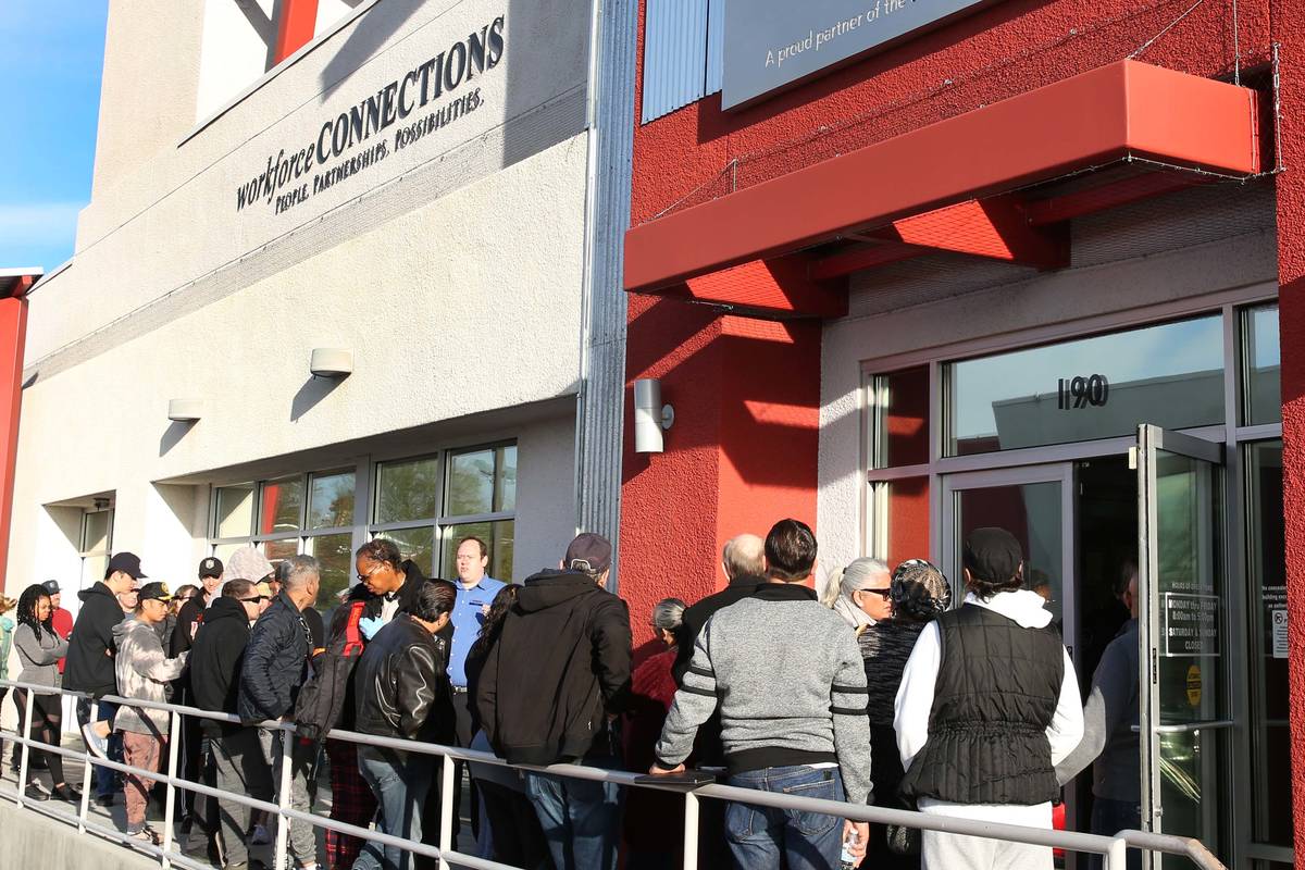 People wait in line at One-Stop Career Center in Las Vegas in this March 16, 2020, file photo. ...