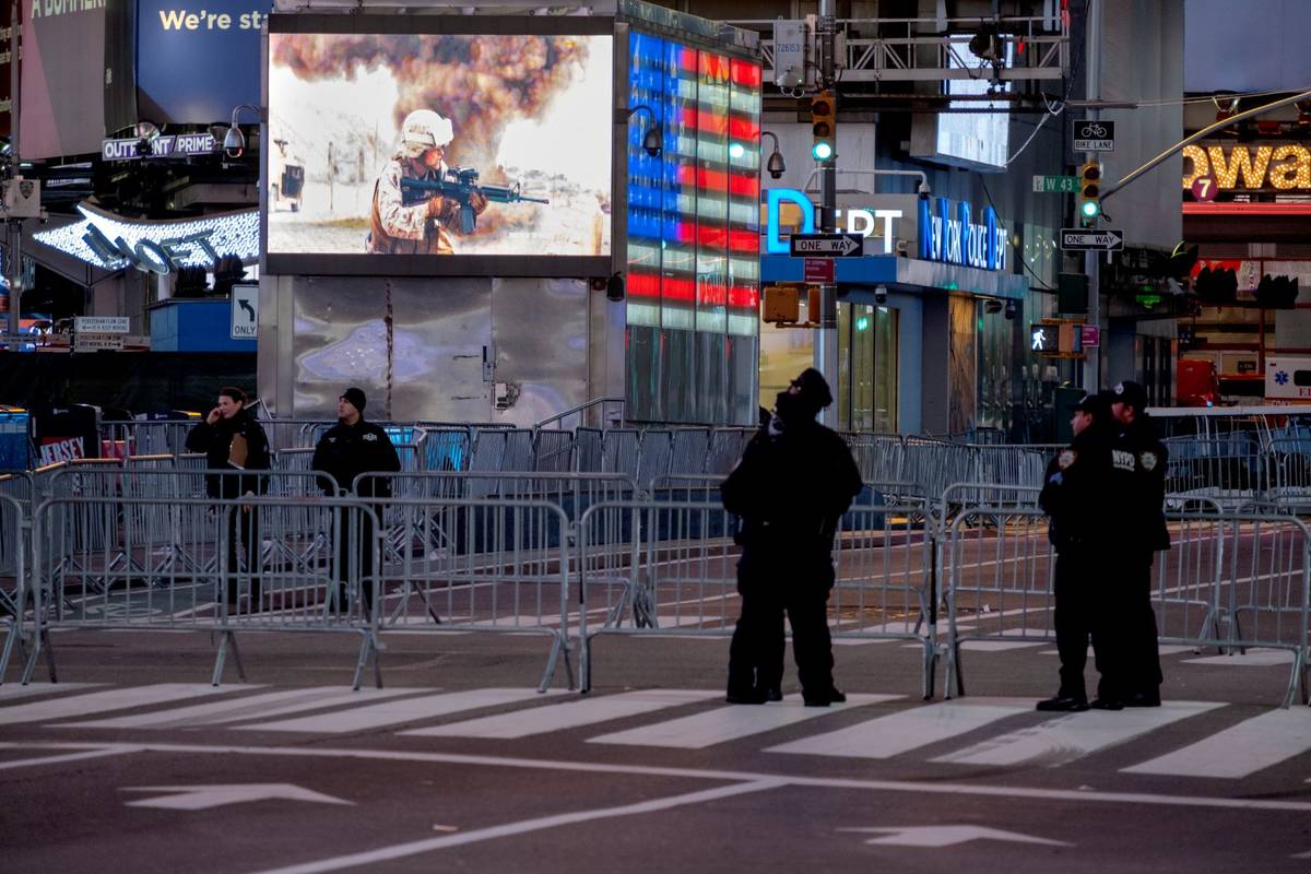 Police officers stand along a mostly empty Seventh Avenue during what would normally be a Times ...