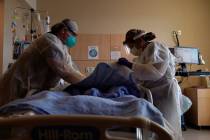 Registered nurses Robin Gooding, left, and Johanna Ortiz treat a COVID-19 patient at Providence ...