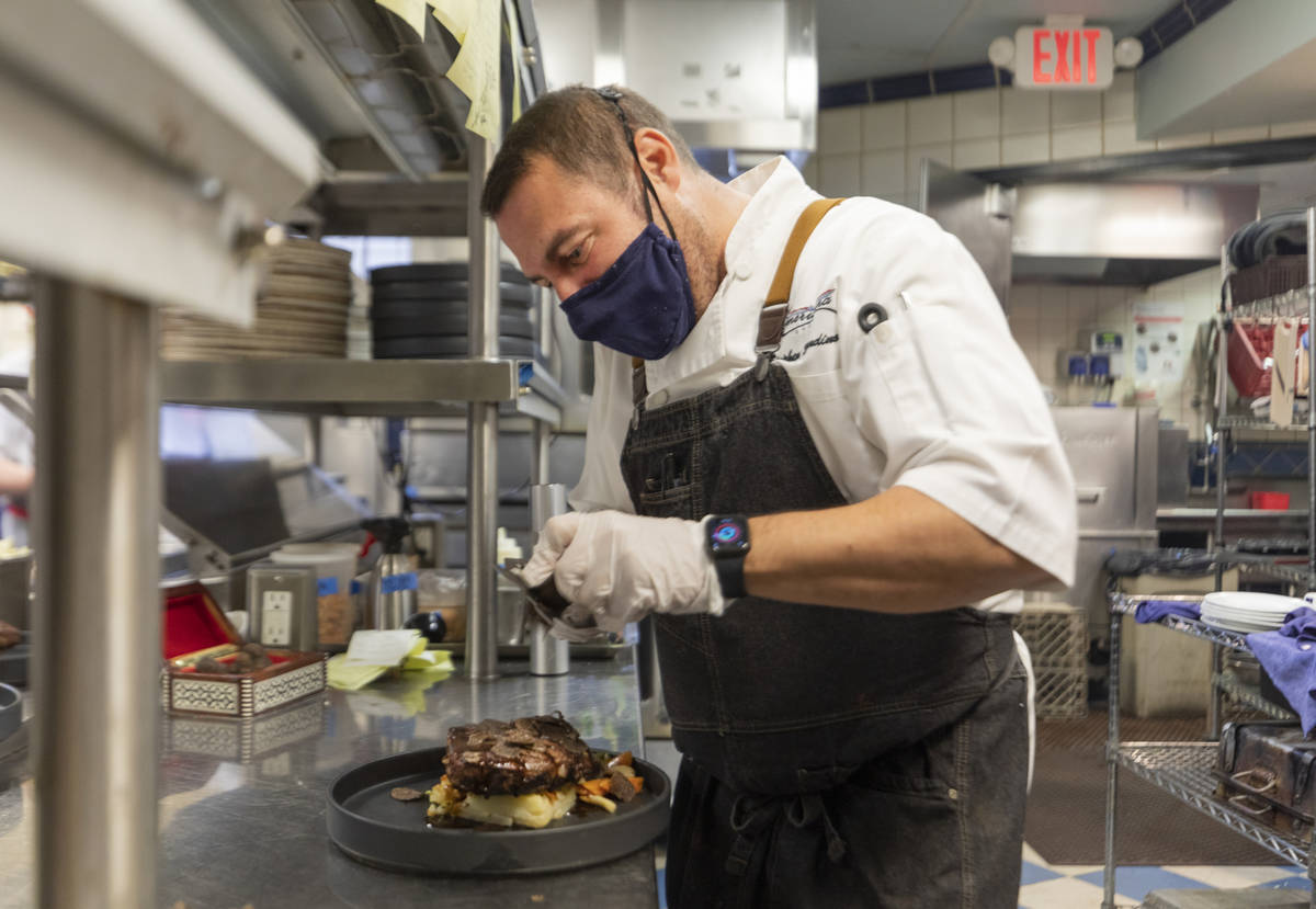 Chef Stephen Blandino finishes a course at Americana on Thursday, Dec. 31, 2020, in Las Vegas. ...