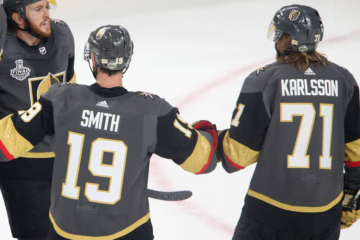 Vegas Golden Knights defenseman Shea Theodore (27) celebrates his score with center Jonathan Ma ...