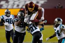 Washington Football Team tight end Logan Thomas (82) leaps over Carolina Panthers outside lineb ...