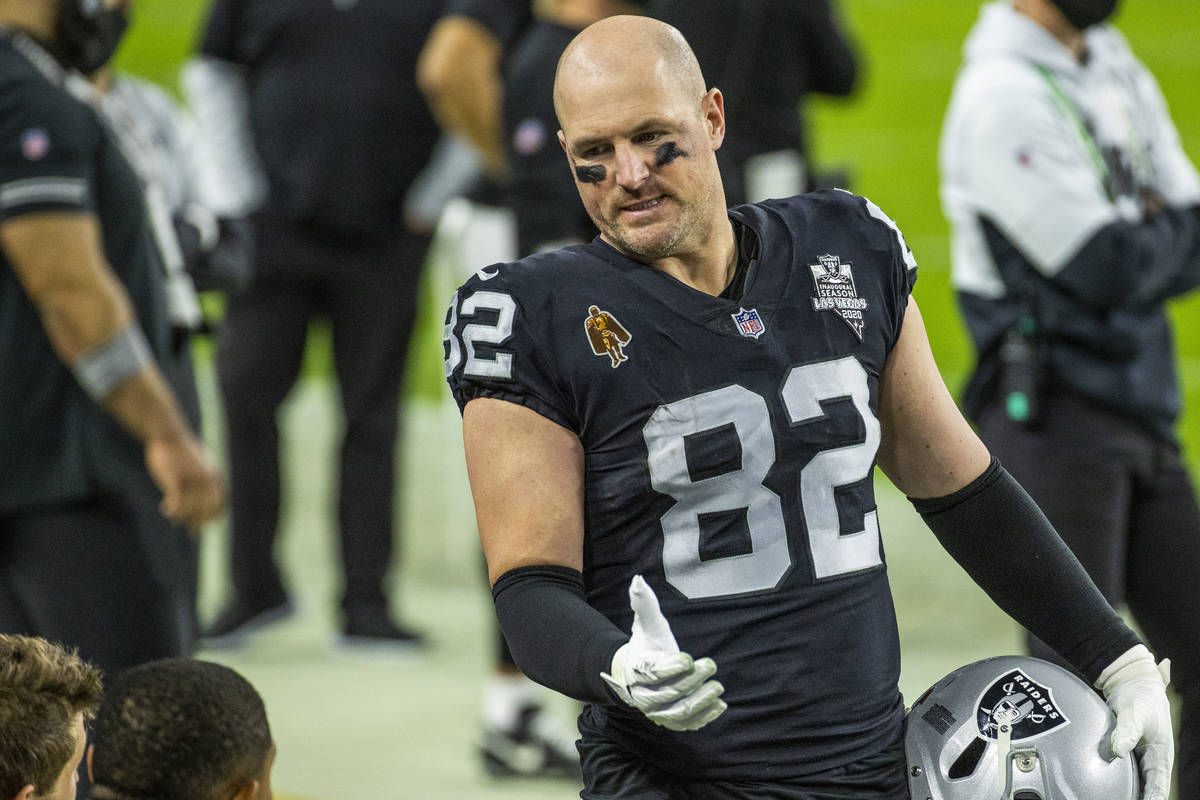 Raiders tight end Jason Witten (82) talks with teammates on the sidelines versus the Miami Dolp ...