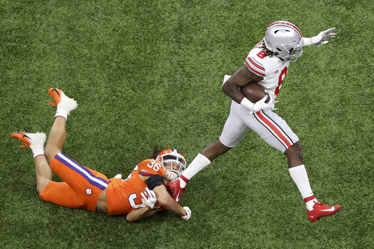 Ohio State running back Trey Sermon, right, breaks away from Clemson safety Lannden Zanders dur ...