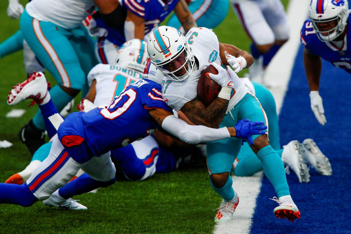 Miami Dolphins running back Myles Gaskin (37) is tackled by Buffalo Bills cornerback Dane Jacks ...
