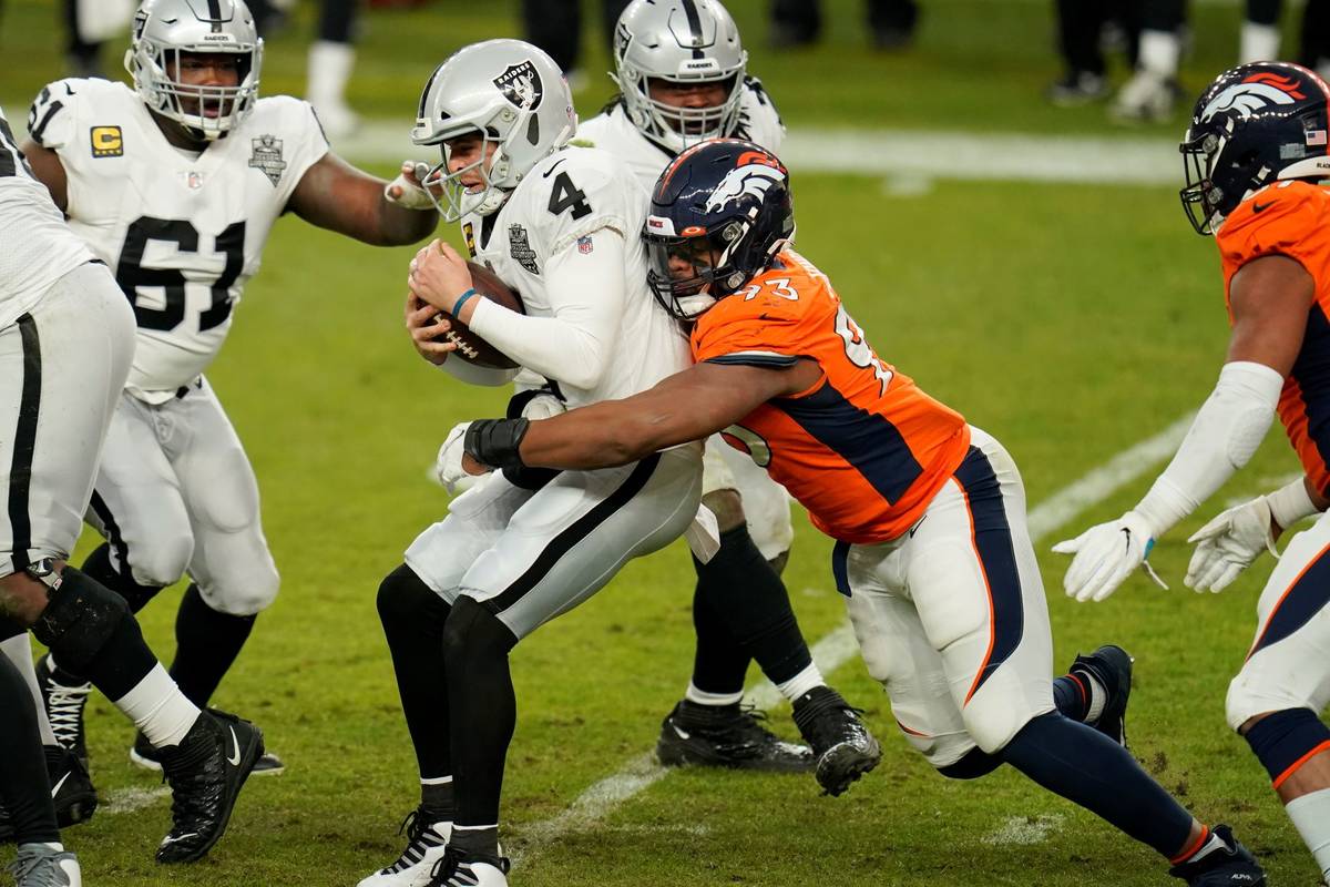 Denver Broncos defensive end Dre'Mont Jones (93) tackles Las Vegas Raiders quarterback Derek Ca ...