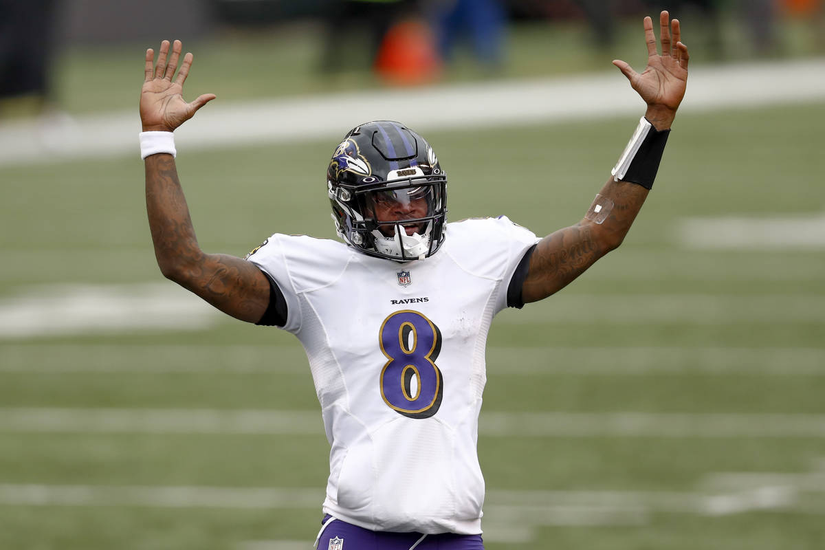 Baltimore Ravens quarterback Lamar Jackson (8) celebrates after running back J.K. Dobbins (27) ...