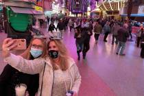 Sisters Christine, left, and Rebecca Loffert celebrate New Year's Eve at the Fremont Street Exp ...