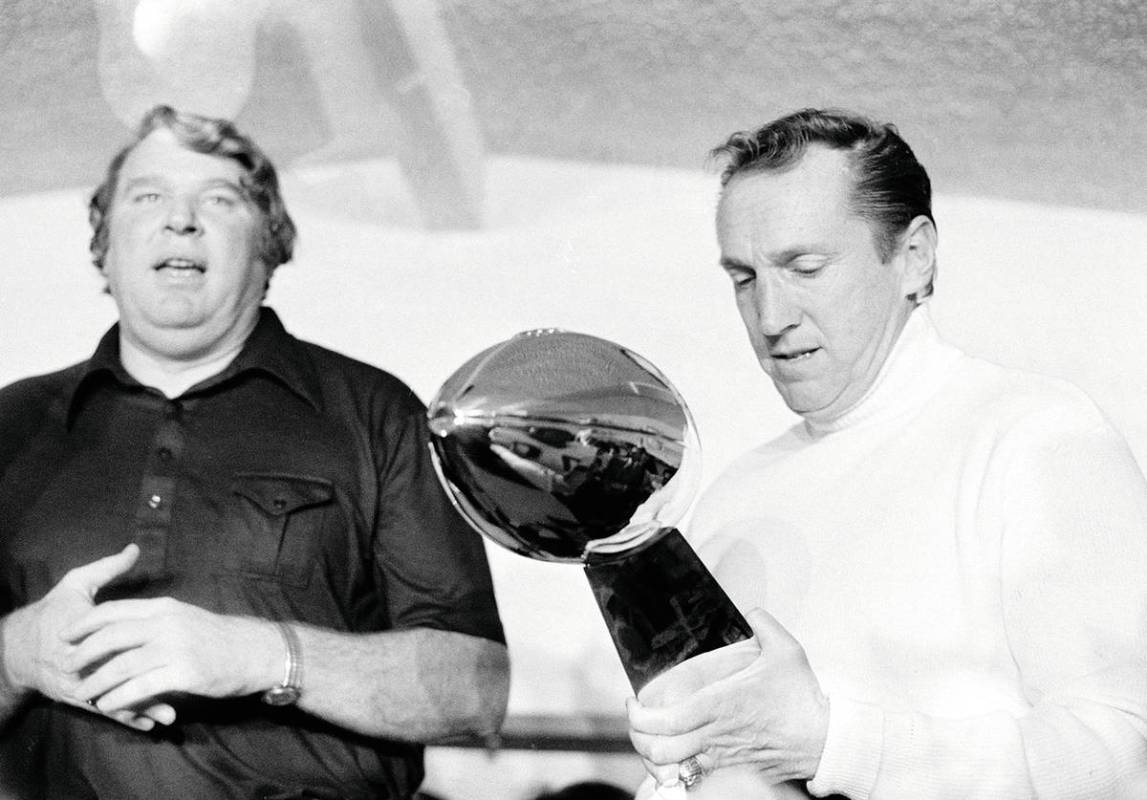 FILE - In this Jan. 9, 1977, file photo, Oakland Raiders coach John Madden, left, talks as team ...