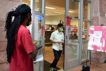 Kenyaday Fitzgerald stand in line outside of the Civil Law Self-Help Center, operated by Legal ...