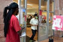 Kenyaday Fitzgerald stand in line outside of the Civil Law Self-Help Center, operated by Legal ...