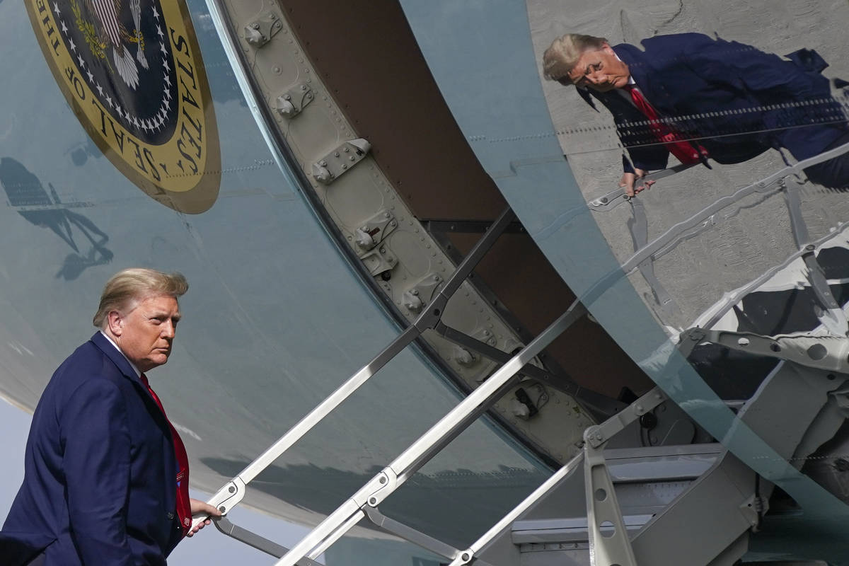 FILE - In this Dec. 31, 2020, file photo President Donald Trump boards Air Force One at Palm Be ...