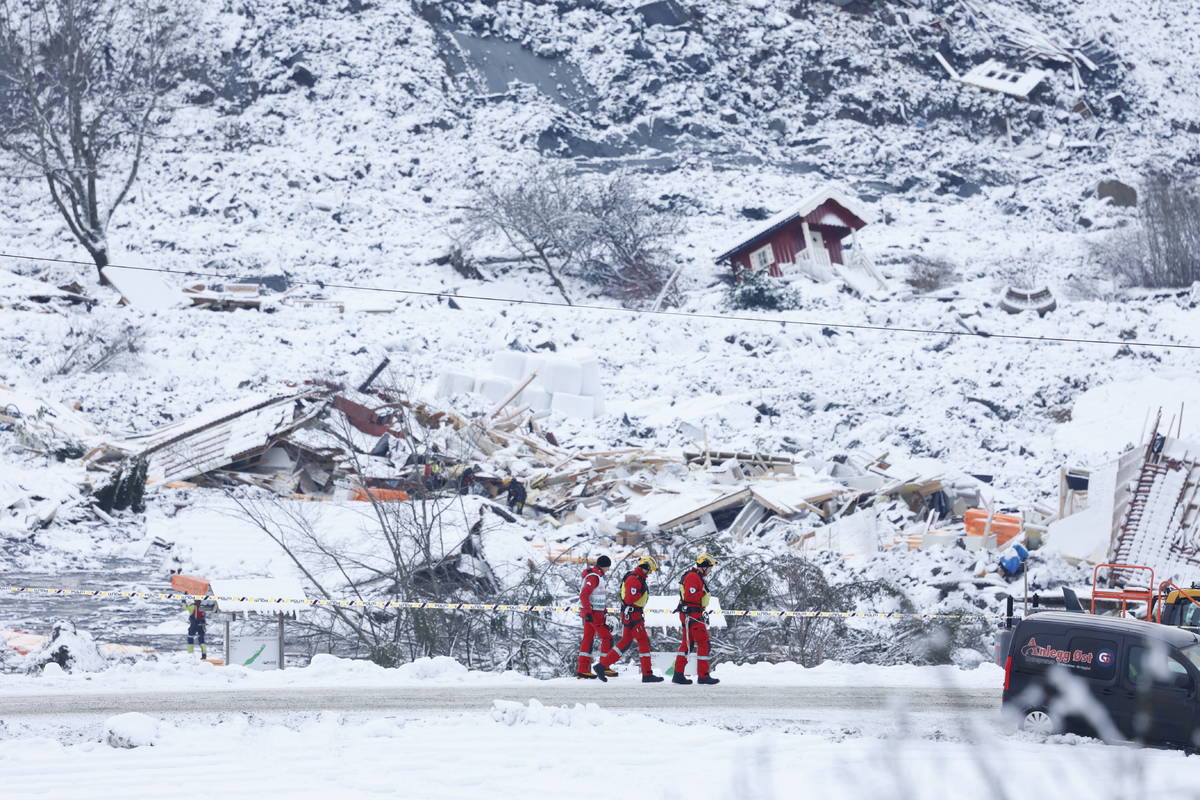 Rescue crews work in the area at Ask in Gjerdrum, Saturday Jan. 2, 2021, after a massive landsl ...
