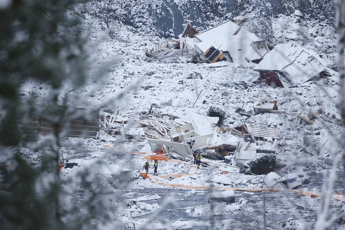 Rescue crews work in the area at Ask in Gjerdrum, Saturday Jan. 2, 2021, after a massive landsl ...
