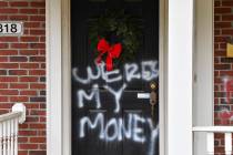 Graffiti reading, "Where's my money" is seen on a door of the home of Senate Majority ...