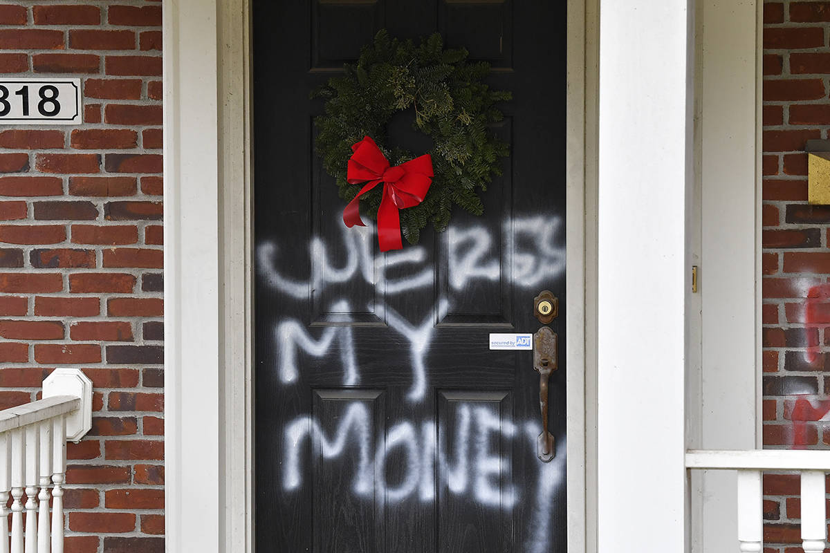 Graffiti reading, "Where's my money" is seen on a door of the home of Senate Majority ...