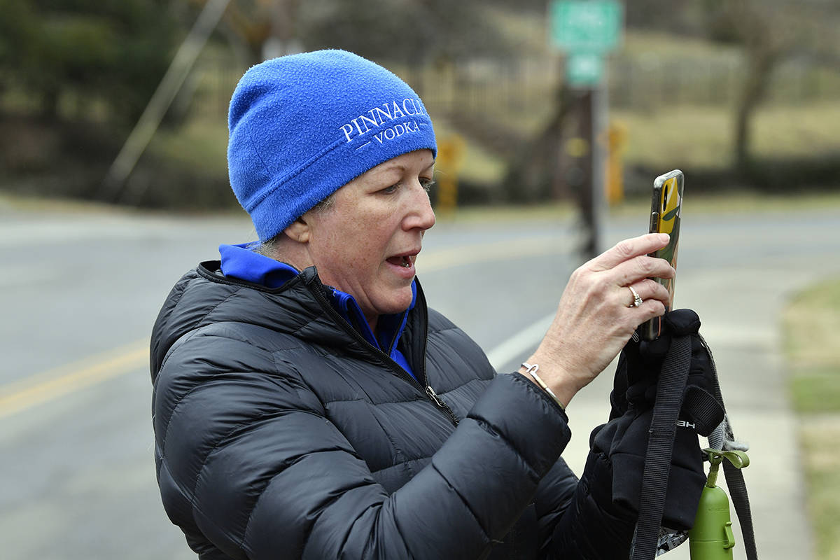 Meredith Downey of Louisville takes photos of the front of the home of Senate Majority Leader M ...