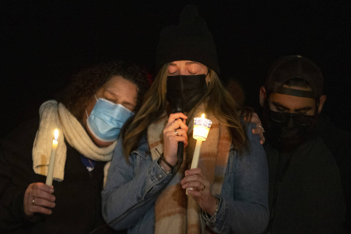 Annmarie Echevarria, left, and Ashley Robledo, center, wife and stepdaughter of Eric Echevarria ...