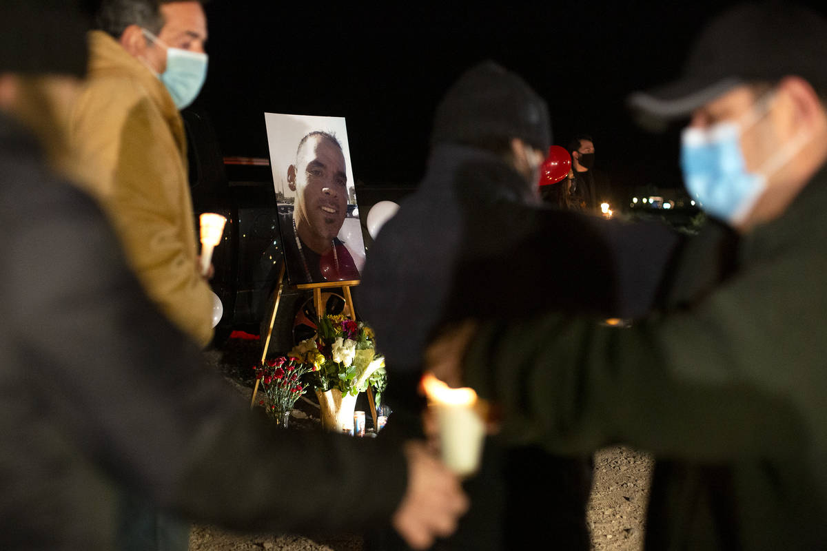 Attendees of a vigil for Eric Echevarria, a 52-year-old father and husband who was killed in a ...