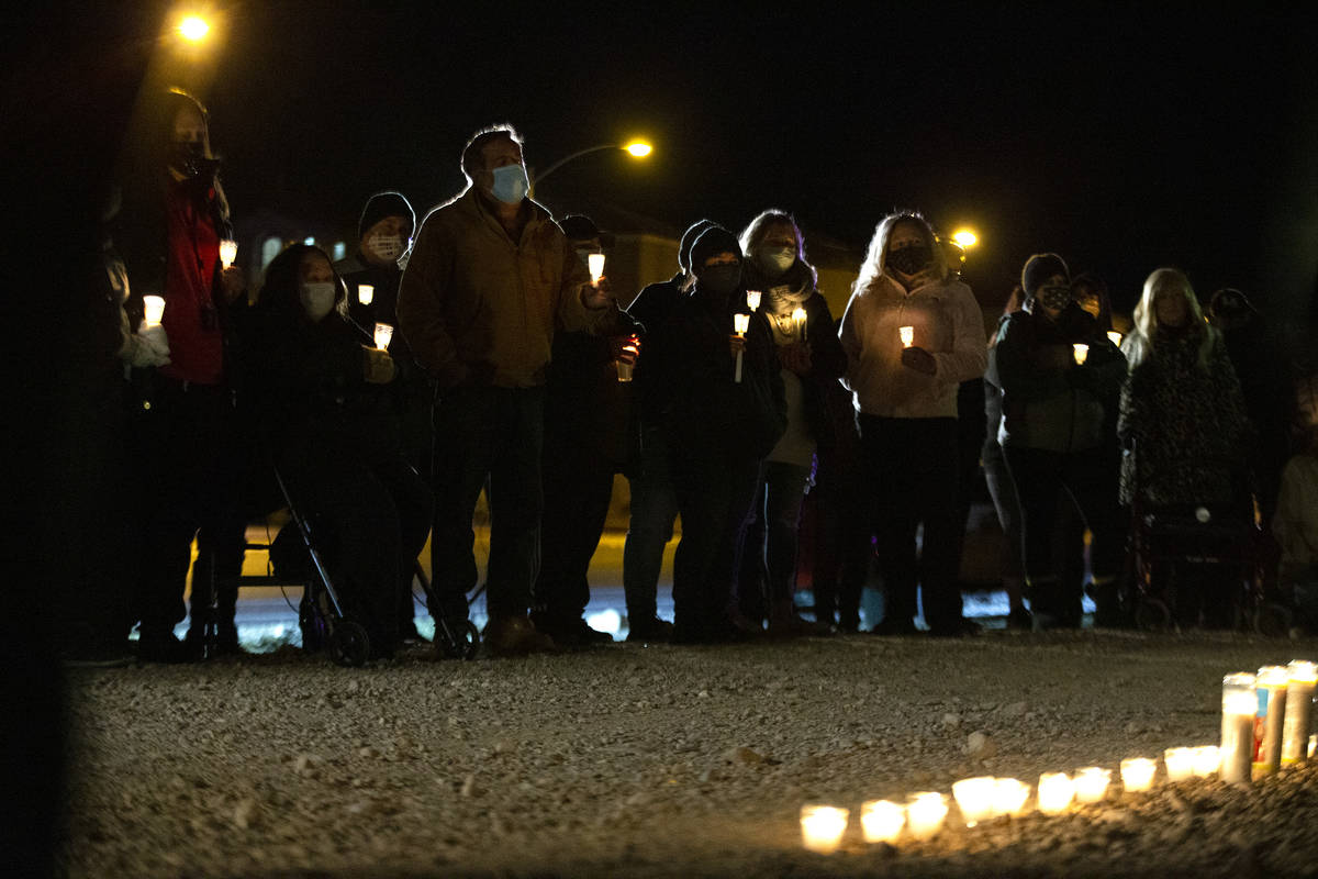 Attendees take a moment of silence for Eric Echevarria, a 52-year-old father and husband who wa ...