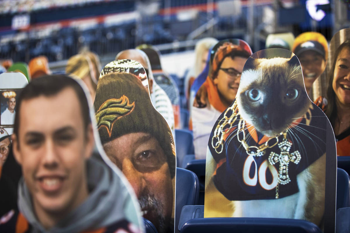 Cardboard cutouts line the stands at Empower Field at Mile High Stadium during an NFL football ...